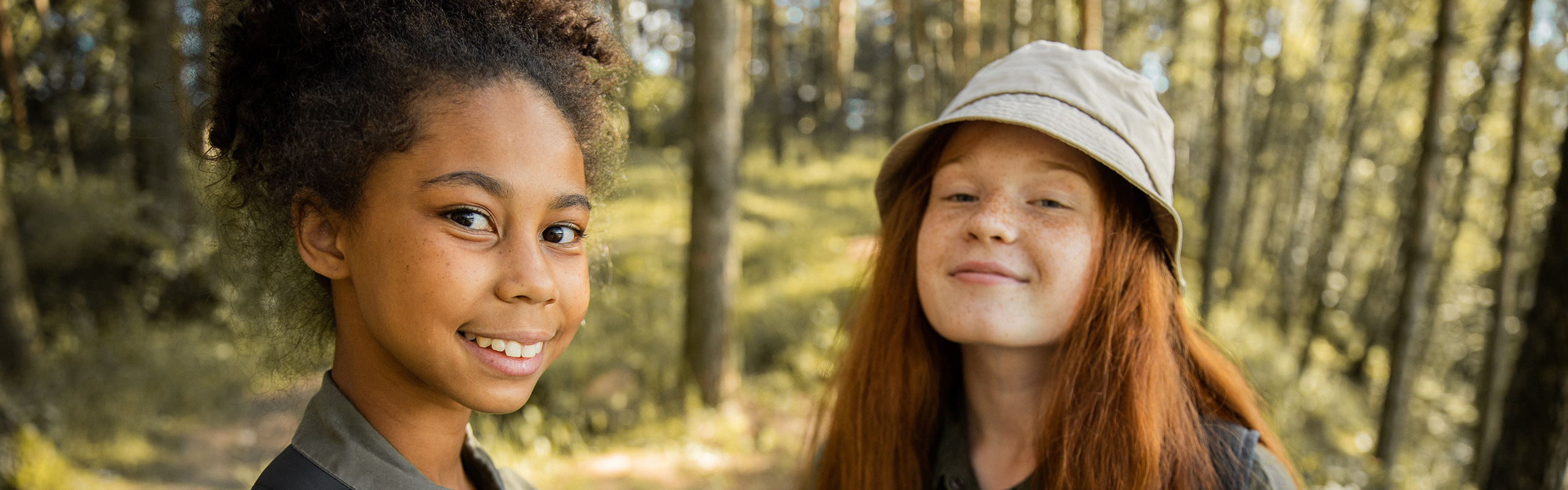 Two girls outside in the woods