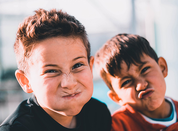 Two boys pulling faces