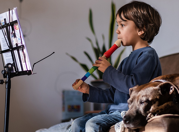 A young boy playing a recorder