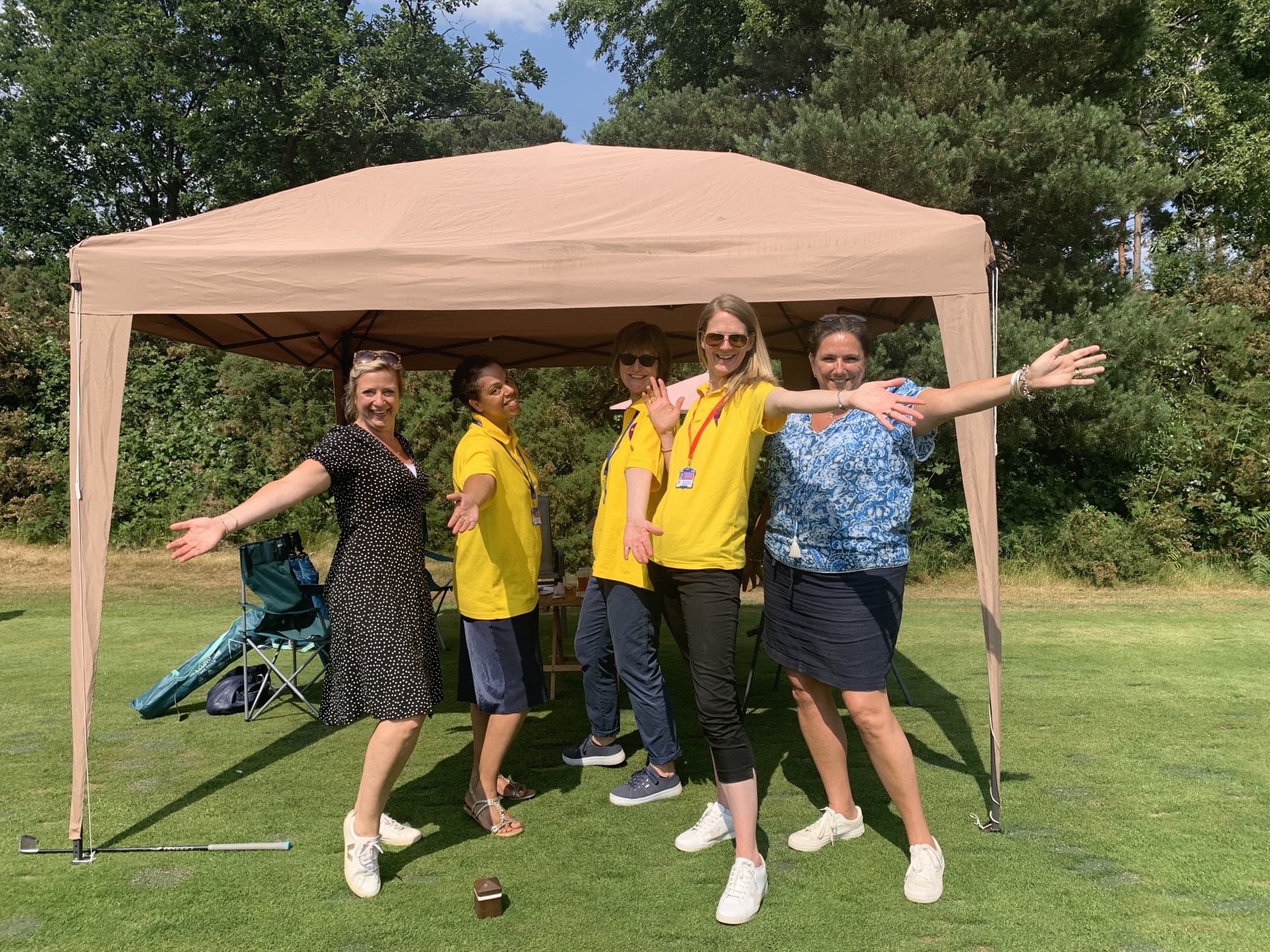 Eikon Team and Woking Golf Club members posing under gazebo