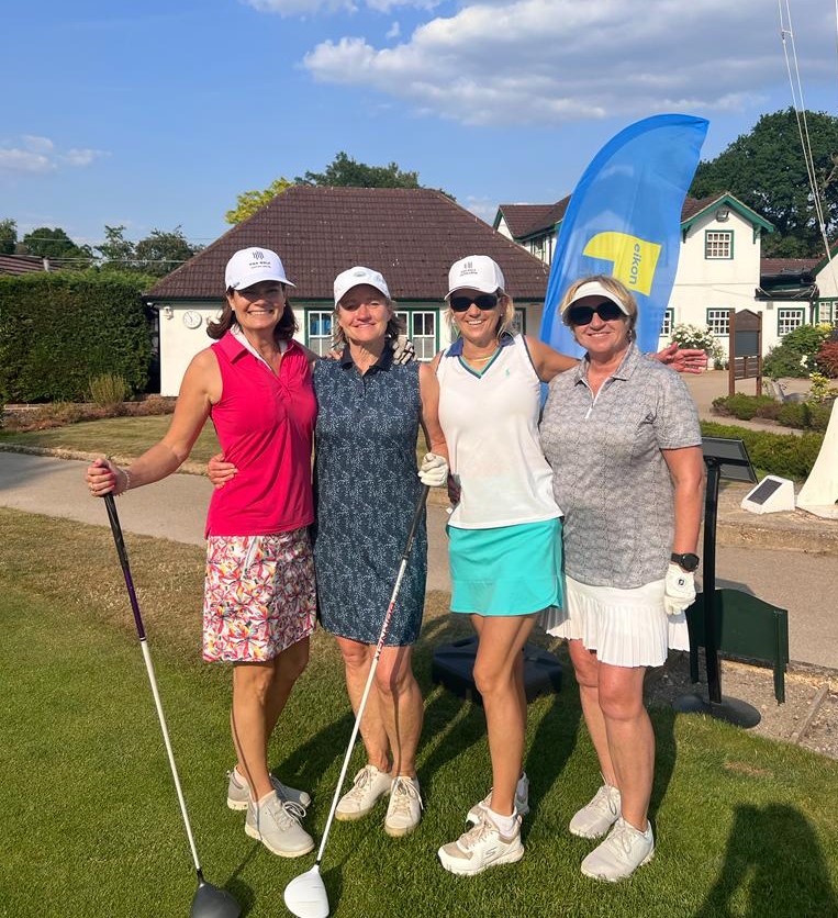 Woking Golf Club members smiling by Eikon banner