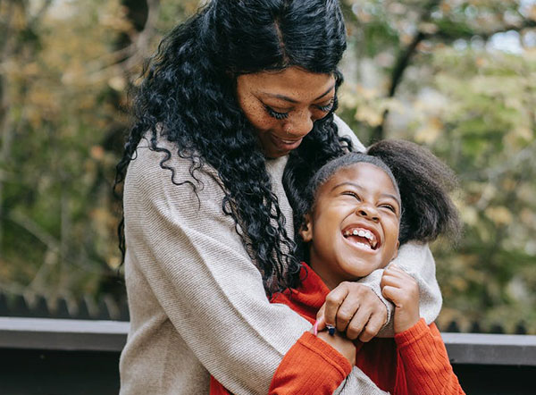 A woman hugging a child